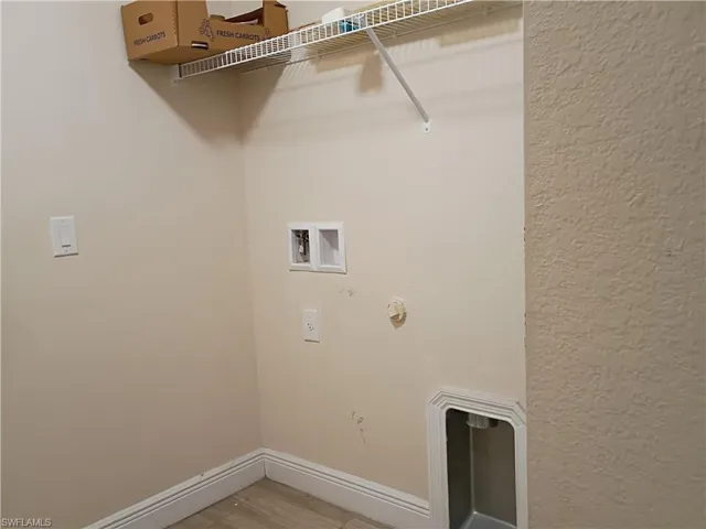 Laundry area with gas dryer hookup, light wood-type flooring, and hookup for a washing machine