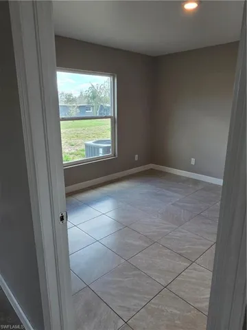 Unfurnished room with baseboards and recessed lighting