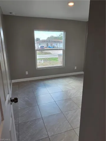 Unfurnished room featuring recessed lighting and light tile patterned floors