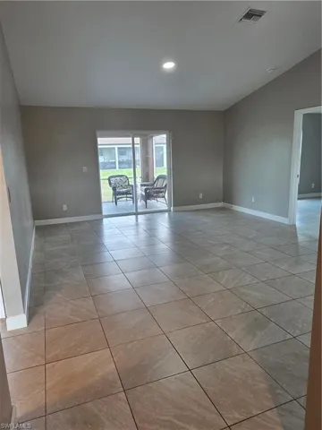 Empty room with recessed lighting and vaulted ceiling