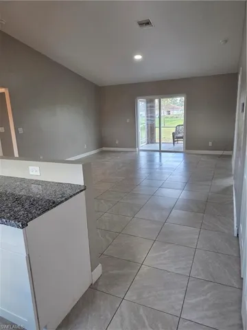 Spare room with light tile patterned flooring and recessed lighting