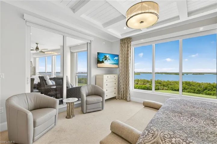 Carpeted bedroom featuring beam ceiling and coffered ceiling