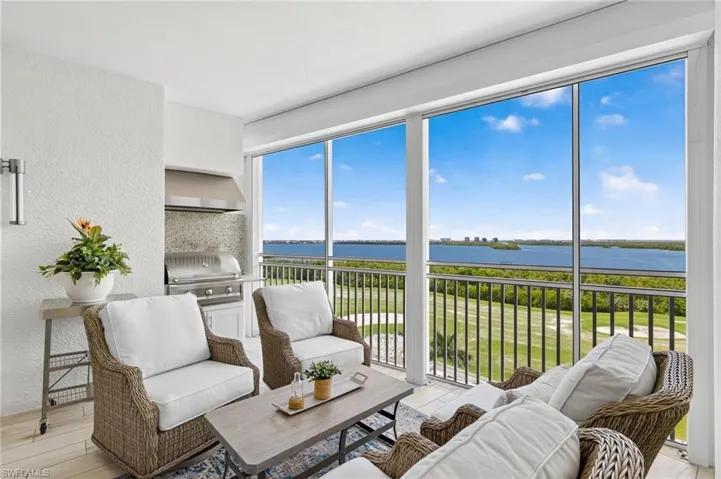 Sunroom / solarium featuring a water view