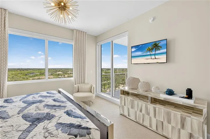 Bedroom with carpet and access to outside