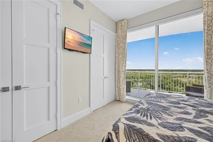 Bedroom with light colored carpet and access to outside