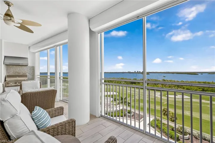 Sunroom / solarium featuring a water view
