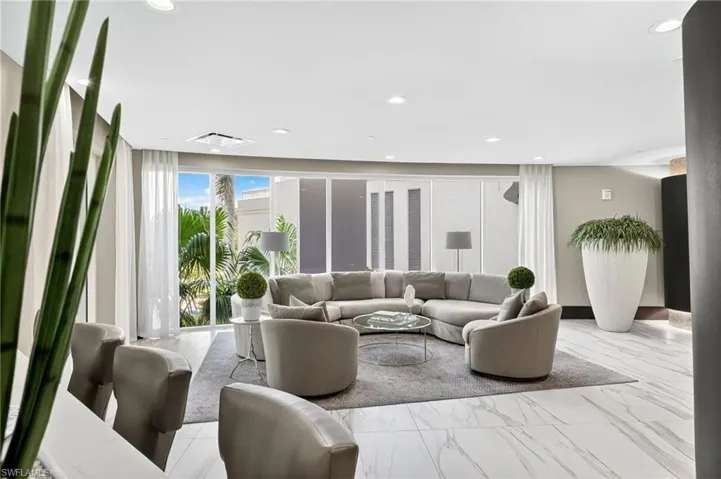 Living area with marble look tiles and recessed lighting