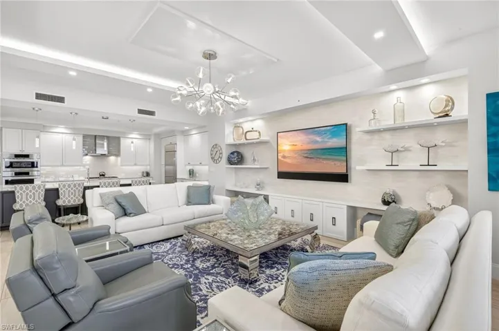 Living room with a chandelier, recessed lighting, and light wood finished floors
