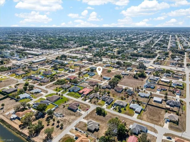 Aerial view of property's location with nearby suburban area