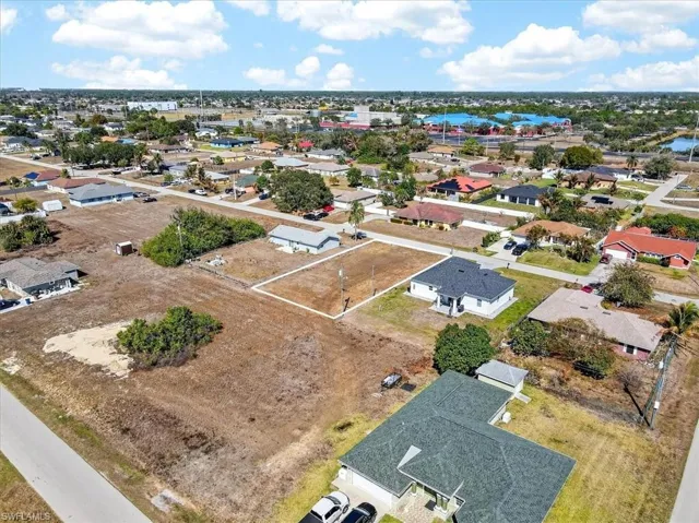 Aerial view of property's location featuring nearby suburban area