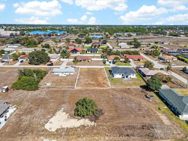 Aerial view of property's location with nearby suburban area