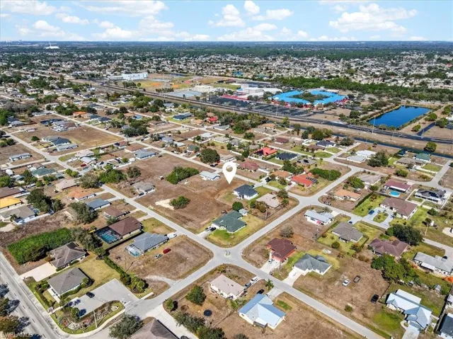 Aerial view of property's location with nearby suburban area and a large body of water