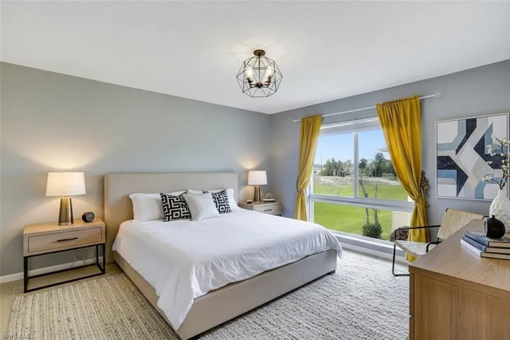 Bedroom virtual staged featuring suspended lighting and a textured ceiling