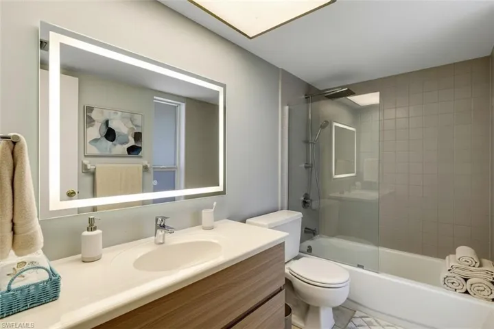 Bathroom- virtual staged- with vanity and shower / bathtub combination