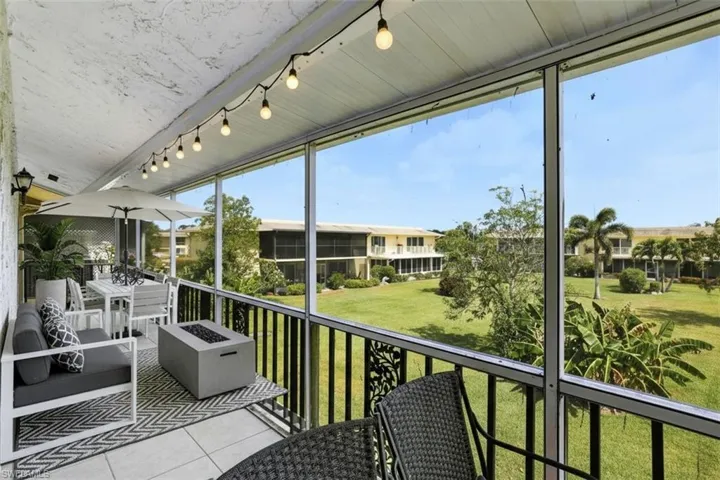 screened virtual staged balcony featuring a balcony, an outdoor fire pit, and outdoor dining area