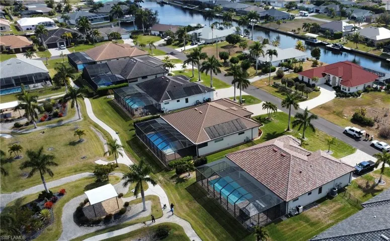 Aerial perspective of suburban area featuring a large body of water