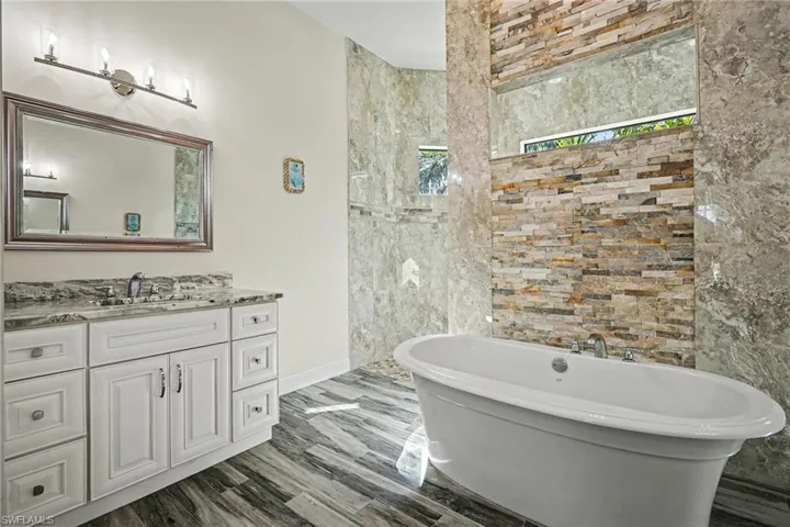 Bathroom featuring vanity and a freestanding tub