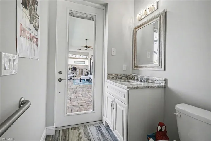 Bathroom featuring vanity, light wood-type flooring, and a ceiling fan