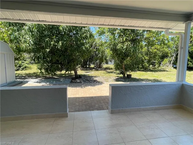 Screened Lanai with fruit trees in the backyard