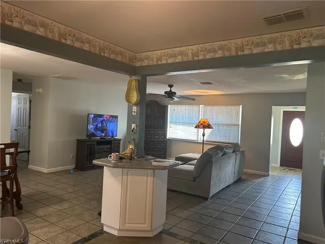 Unique well placed kitchen Island, living room with ceiling fan
