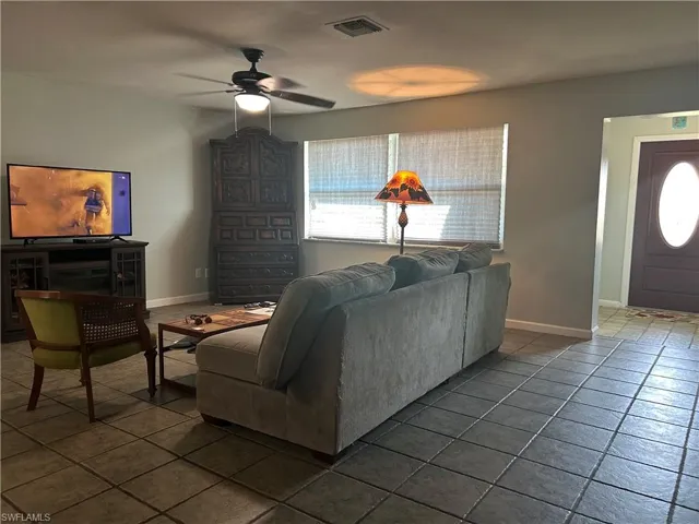 Huge living room wall to wall tile floors and ceiling fan