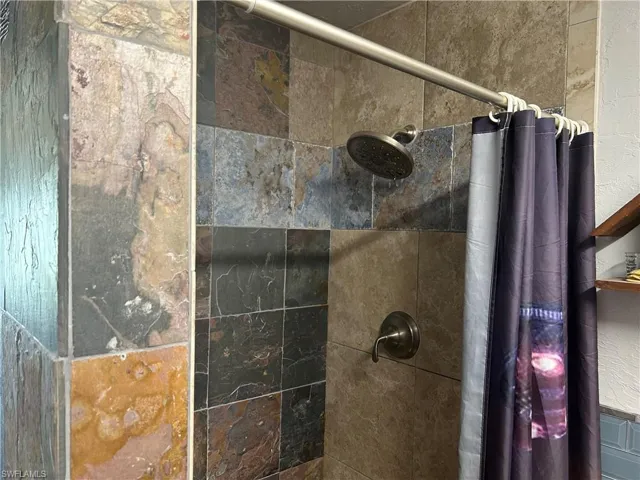 Primary bath featuring custom tiled shower