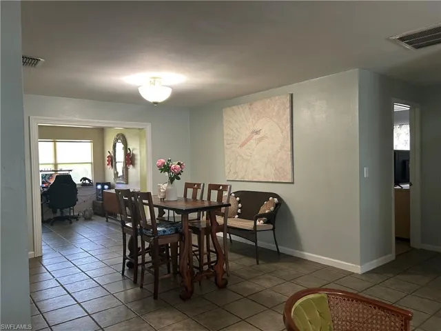 View of dining room, (kitchen on left) step down to extra living space!!