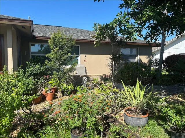 View of front of home, has private sitting area surrounded by a butterfly garden!!