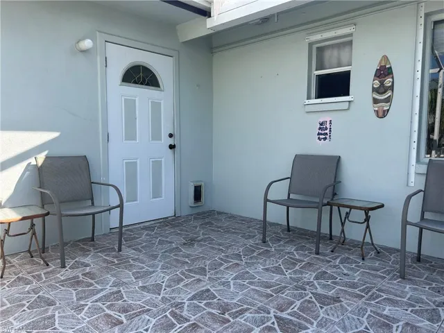 View of exterior entry with a screened  patio area