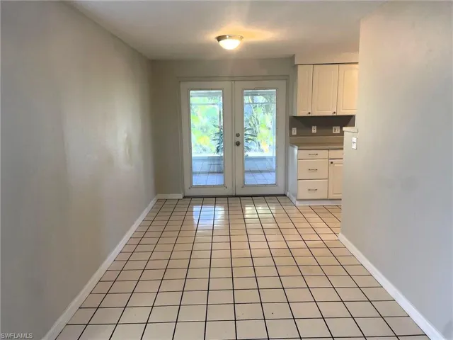 Entryway with french doors and tile patterned floors
