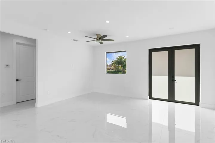 Spare room featuring french doors and ceiling fan