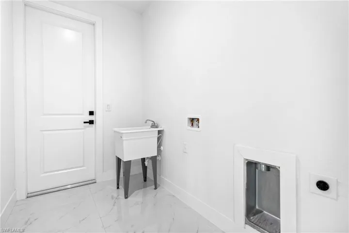 Laundry room with hookup for a washing machine and electric dryer hookup