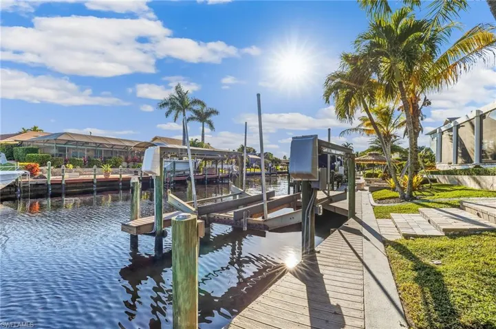 Dock with boat lift and a water view
