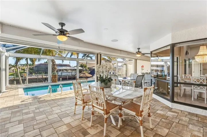 Sunroom / solarium featuring a water view
