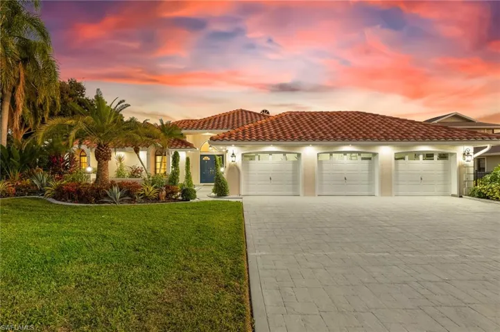 Mediterranean / spanish-style home featuring decorative driveway, stucco siding, an attached garage, and a front lawn