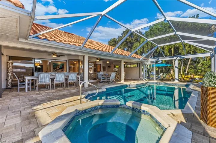 View of swimming pool with a patio, a sunroom, ceiling fan, outdoor dining space, and glass enclosure