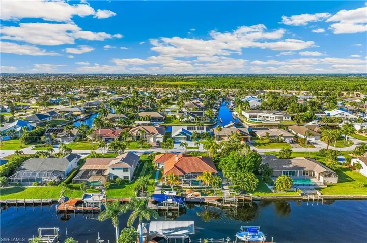 Aerial perspective of suburban area featuring a large body of water
