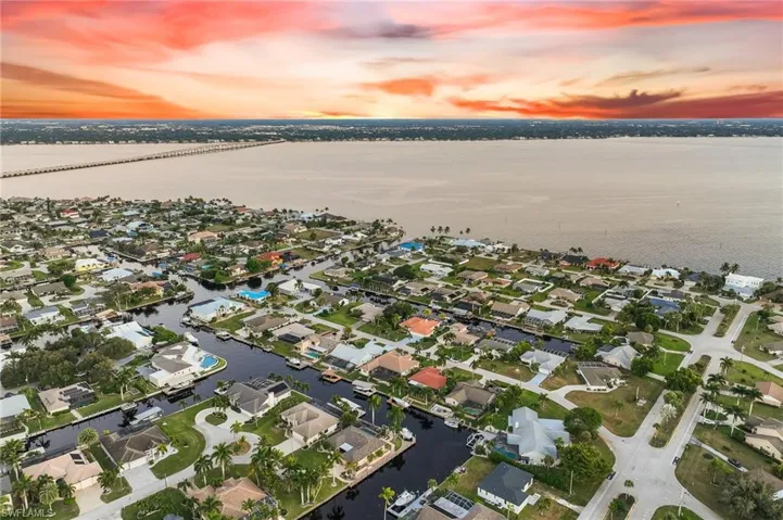 Aerial view at dusk of a water view and a residential view