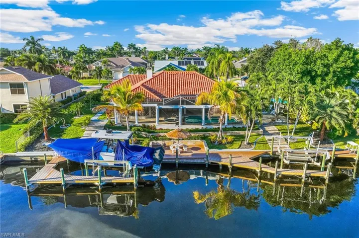 Dock area featuring boat lift, a water view, a residential view, and a patio area