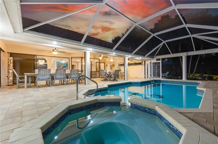 View of pool featuring a pool with connected hot tub and a sunroom