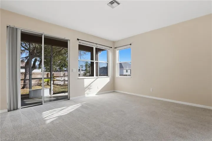 Empty room featuring baseboards and light colored carpet
