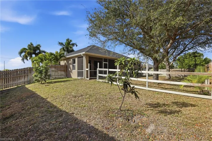 Fenced backyard with a sunroom