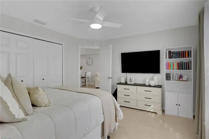 Bedroom featuring a ceiling fan and a closet