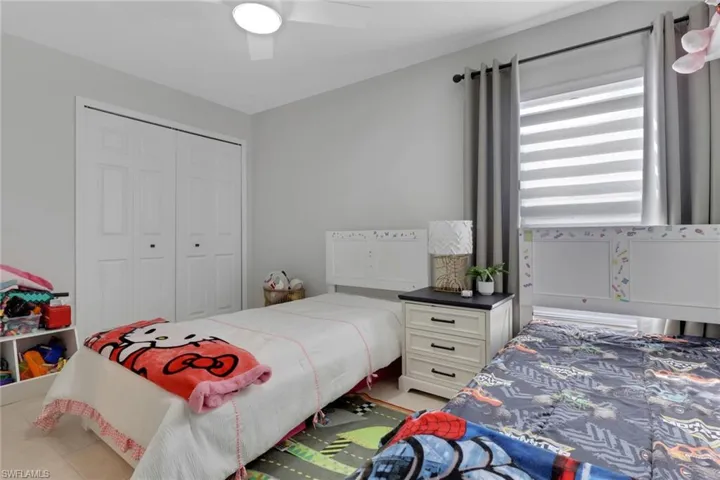 Bedroom featuring a ceiling fan and light tile patterned flooring
