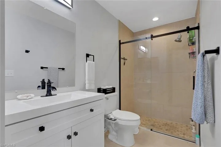 Bedroom with a ceiling fan and baseboards