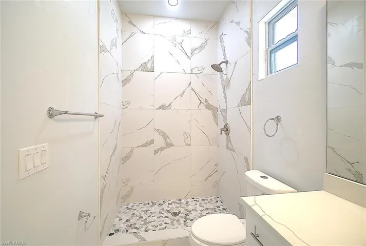 Full bath with a stall shower and vanity