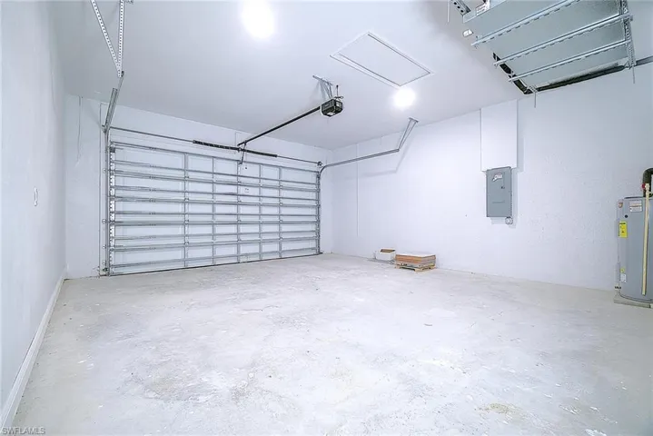Garage with water heater and electric panel