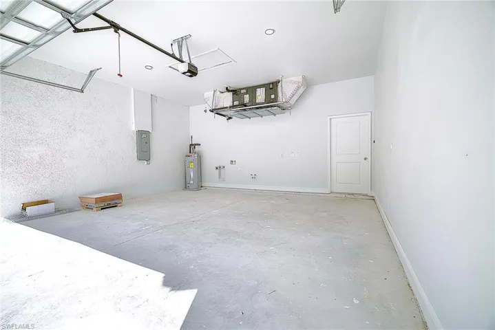 Garage with water heater and electric panel
