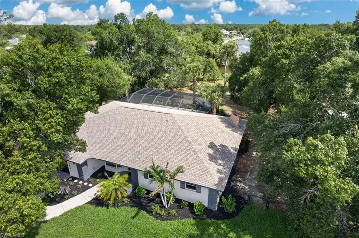 Aerial view of a single-story residence with a gray shingle roof