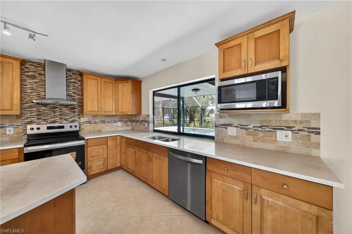 Kitchen featuring light wood cabinetry and light-toned countertops